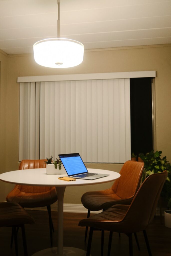 a laptop computer sitting on top of a white table
