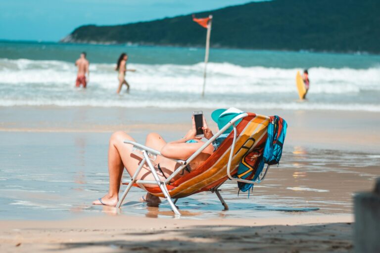 woman lying on orange and yellow sun lounger on beach during daytime